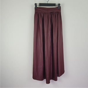 Burgundy faux leather midi skirt. Longer in back,elastic waist size Medium